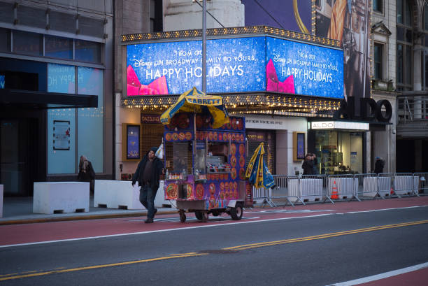 Manhattan, New York. December 29, 2020. Street vendor pulls a concession stand on 42nd street.