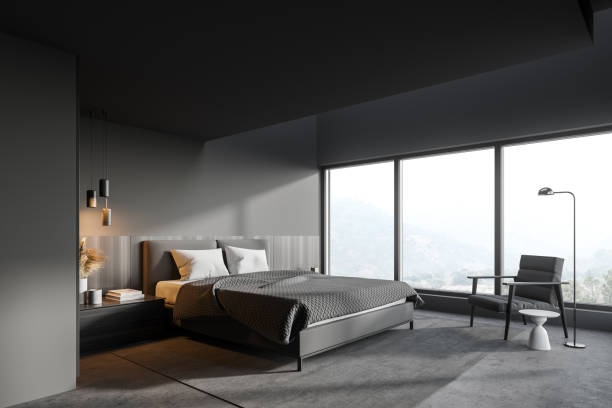 istock Gray master bedroom corner with bed and armchair 1294346482