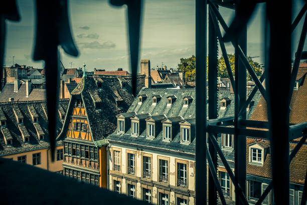 Old medieval architecture seen through wrought iron window grate from Strasbourg France
