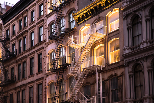 View of beautiful New York City apartment buildings lit up in the evening