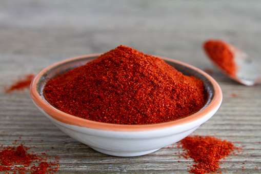 Paprika and black pepper on a white background