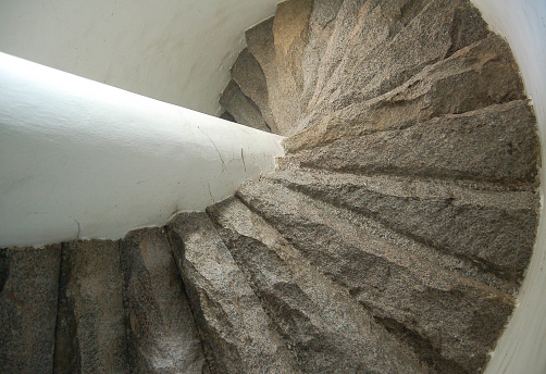 Looking down at the well-worn steps of a circular stairwell