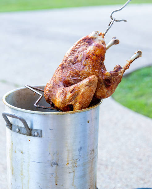 istock Pulling a deep fried turkey out of the fryer 1294368629