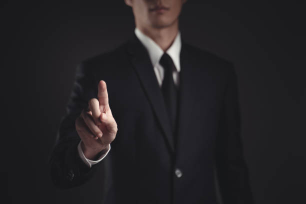 istock Businessman presenting in black suit. 1294372103