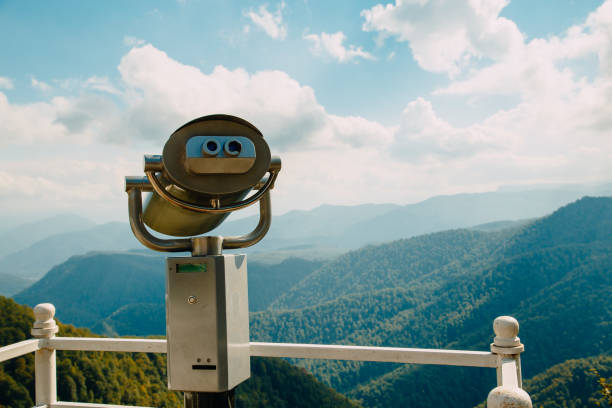 istock Binoculars with coins overlooking the Blue Mountains, Landscape with beautiful cloudy sky and mountains .. 1294380164