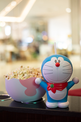Bangkok, Thailand - January 3, 2020 : Cute toy of Doraemon set of bucket popcorn and soft drink to promote the movie : Nobita's New Dinosaur from Advertising Major Cineplex Group Plc.