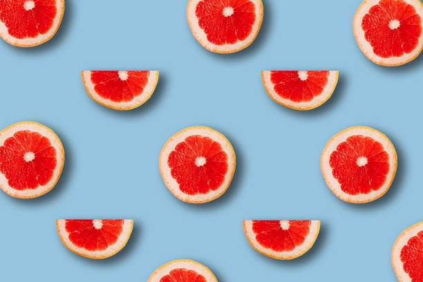 istock summer pattern with red juicy ripe fresh grapefruit on a blue background 1294381880