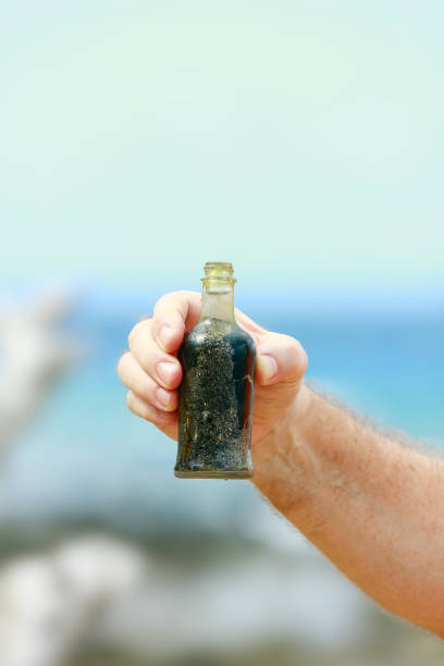 istock Hand held bottle,just one example of the problem of global ocean pollution. 1294383167