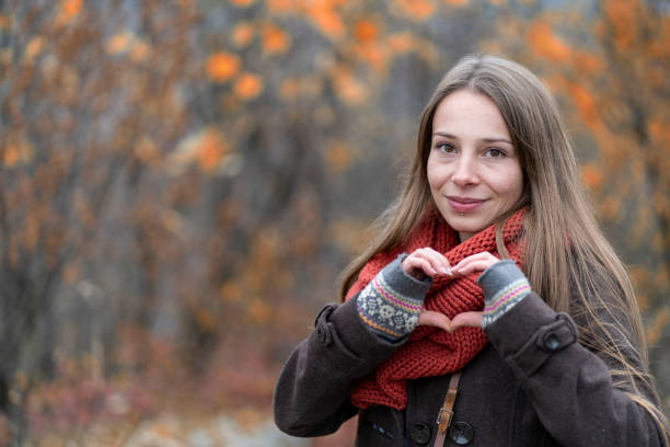istock Young woman makes heart shape finger frame 1294383328