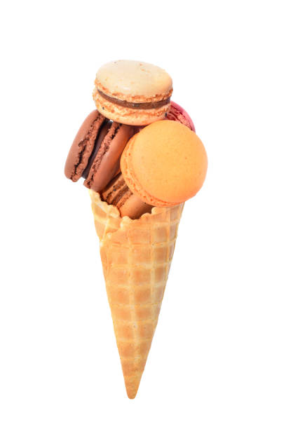 istock Macaroons assorted in ice cream cone waffle isolated on white 1294383354
