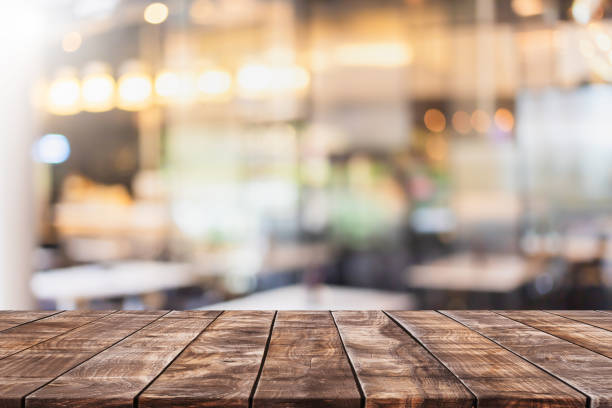 istock Empty wood table top and blurred coffee shop and restaurant interior background - can used for display or montage your products. 1294384083