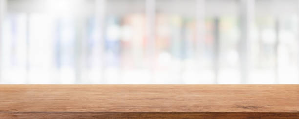 istock Empty wood table top and blur glass window interior restaurant and cafe banner mock up background - can used for display or montage your products. 1294384092