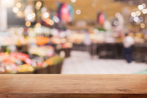 istock Empty wood table top and blurred supermarket and grocery store interior background - can used for display or montage your products. 1294384178