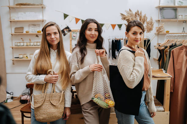 istock Three women in ecological shop posing with different eco bags 1294385209