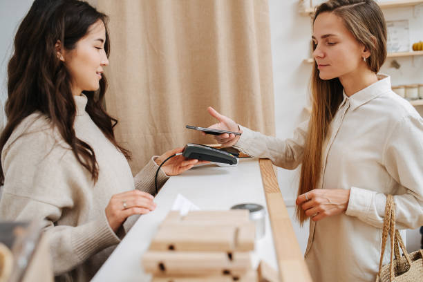 istock Comfortable female customer making a purchaise, paying with her phone. 1294385225