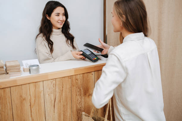 istock Happy female customer making a purchaise, paying with her phone. 1294385239
