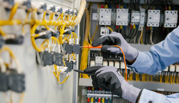 istock Electrical engineers test electrical installations and wiring on protective relays, measuring them with a multimeter. 1294385293