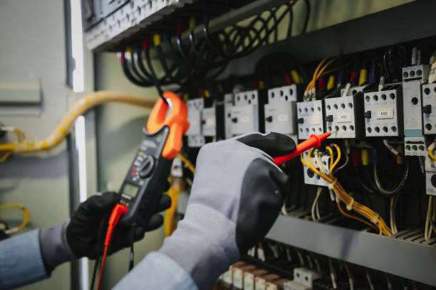 istock Electrical engineers test electrical installations and wiring on protective relays, measuring them with a multimeter. 1294385300