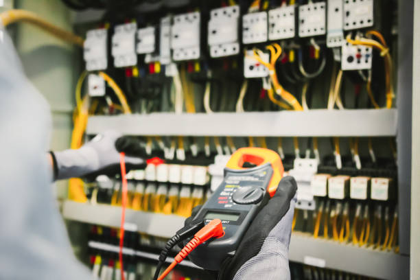 istock Electrical engineers test electrical installations and wiring on protective relays, measuring them with a multimeter. 1294385306