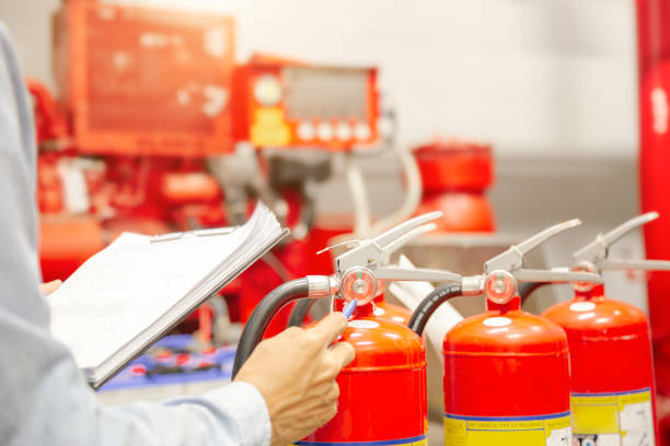 istock Engineer inspection Fire extinguisher and fire hose. 1294385360