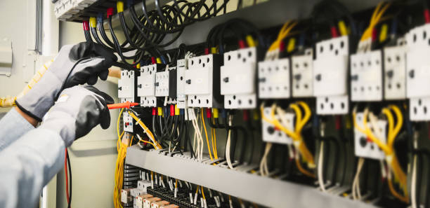 istock Electrical engineers test electrical installations and wiring on protective relays, measuring them with a multimeter. 1294385380