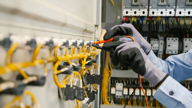 istock Electrical engineers test electrical installations and wiring on protective relays, measuring them with a multimeter. 1294385381