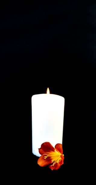 istock Candle on a black background, postcard, Flat Lai on death and funeral 1294386105