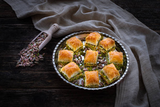 Baklava with pistachio in the plates. Carrot piece ( havuc dilim ) and dry ( kuru ) baklava. Desserts with sugar syrup. gaziantep city stock pictures, royalty-free photos & images