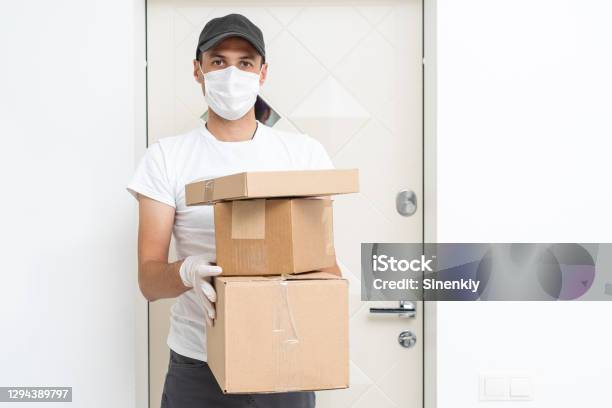 Courier Delivery Man In Medical Latex Gloves And Mask Safely