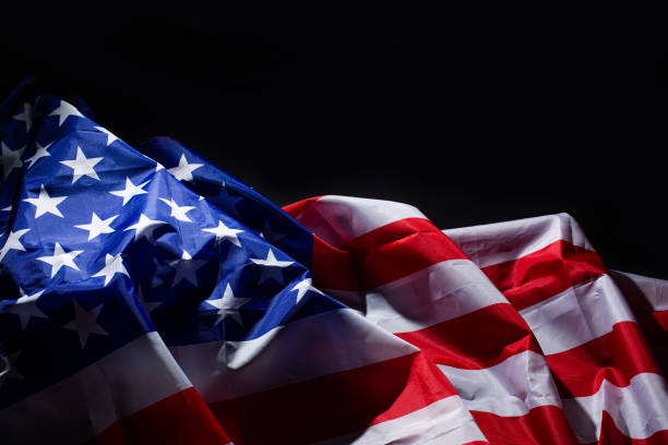 istock American flag lying on black background 1294391266