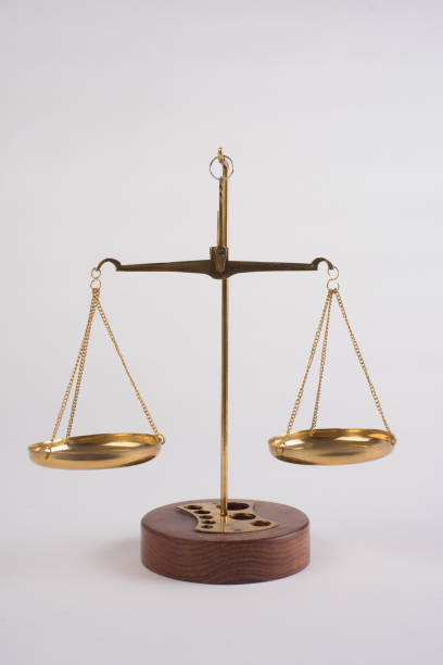 istock Gold brass balance scale isolated on white background. 1294391520