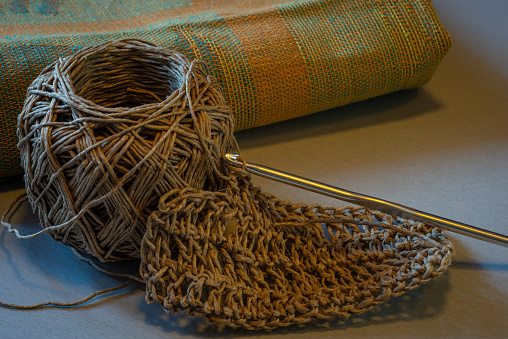 home made Twine tawashi & crochet hook on kitchen table.zero waste kitchen.
