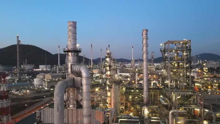 4k Aerial shot of combine cycle powerplant and cooling tower. Oil refinery plant from industry zone, Aerial view oil and gas industrial, Refinery factory oil storage tank and pipeline steel