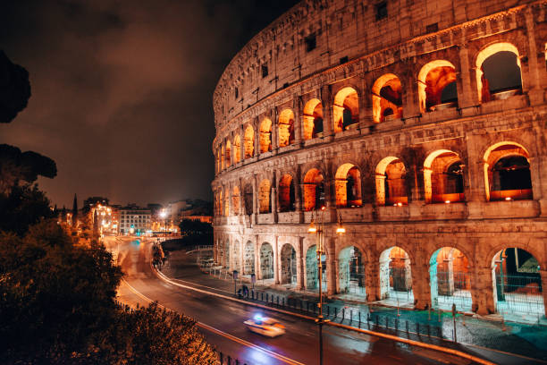 istock coliseum at night during the lockdown with police 1294396726