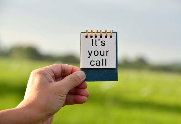 istock Hands Holding A Notepad With Text Written And Blurred Green Background 1294396741
