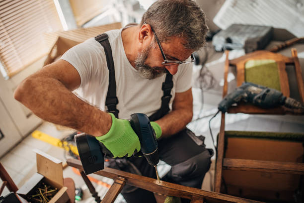 istock Old carpenter repairing a chair 1294397326