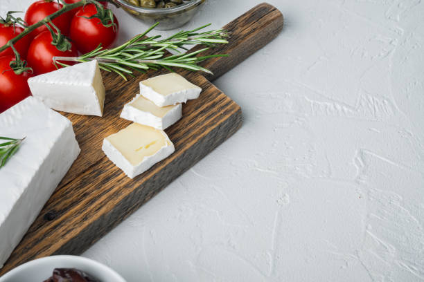 istock Antipasti platter with fresh cheese, bread and olives, on white background  with copy space for text 1294397403