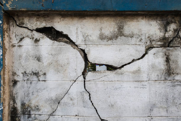istock old cement wall had cracks caused by impact 1294398236