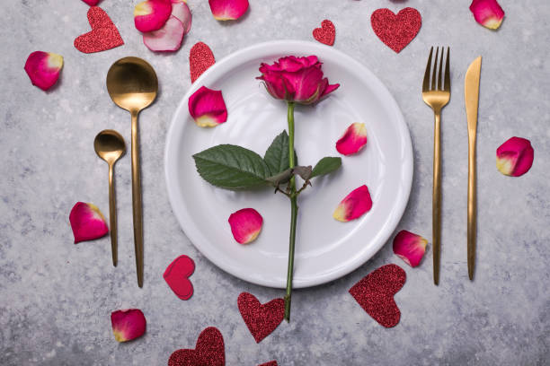 istock Valentines dinner with table place setting  hearts decoration, rose for valentines days dinner. View from above. 1294398299