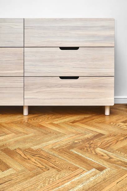 istock Chest of drawers with finger pull sliders on parquet floor 1294398306