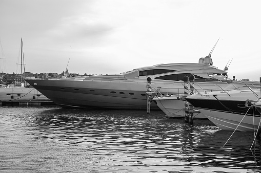 Wintertime view of a pier for leisure boats moorage, on the Viverone Lake shores; small lake of glacial origin, is located in Northern Italy, Piedmont Region.