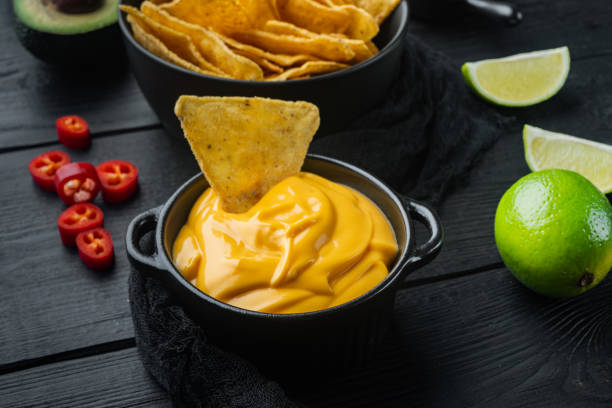 istock Bowl with cheese sauce, on black wooden background 1294400105