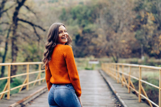 istock Smiling young woman enjoys in nature 1294401432