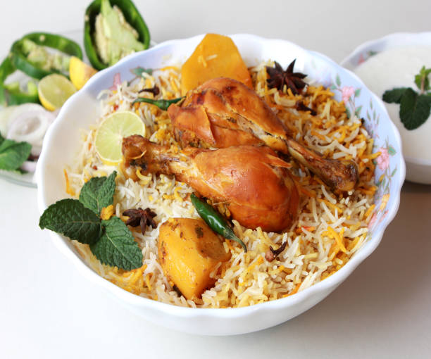 Isolated delicious spicy chicken biryani in white bowl on white background, Indian or Pakistani ramzan food. Beautiful view of traditional spicy indian food, Iftar meal, Ramadan dinner.