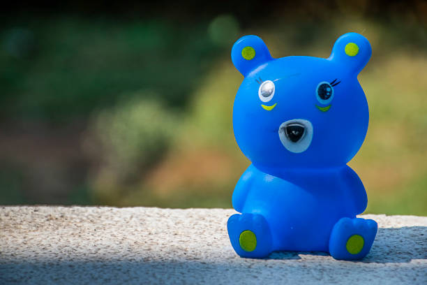 Cute blue color small bear toy on the floor, blurred background stock photo