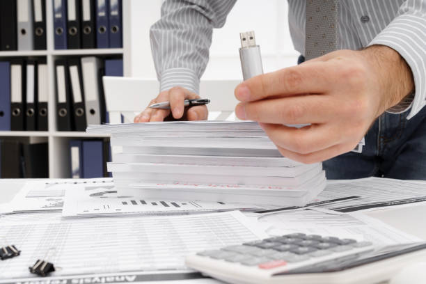 istock business concept - businessman's working table close view, shows the USB flash drive 1294402601