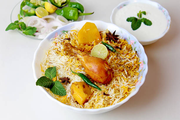 Isolated delicious spicy chicken biryani in white bowl on white background, Indian or Pakistani ramzan food. Beautiful view of traditional spicy indian food, Iftar meal, Ramadan dinner.