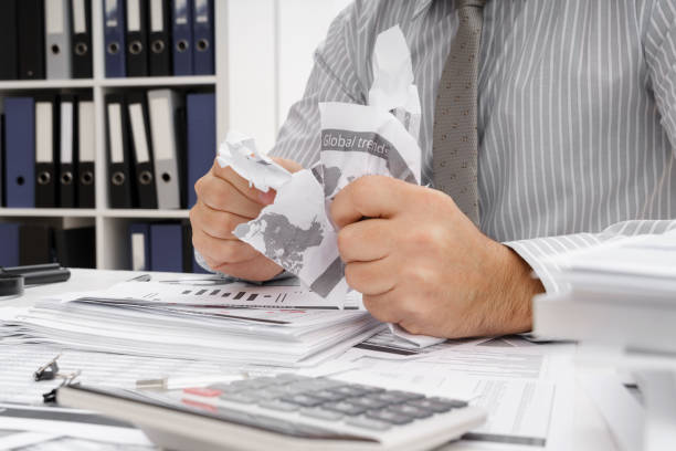 istock business problem concept - disappointed businessman has trouble and tears up reports 1294403316