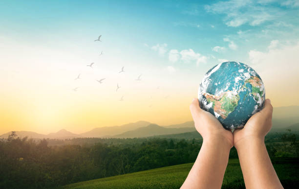 Corporate social responsibility (CSR) concept Human hands holding global over green mountain background. Original source from Nasa on https://visibleearth.nasa.gov/images/54388/earth-the-blue-marble world environment day stock pictures, royalty-free photos & images