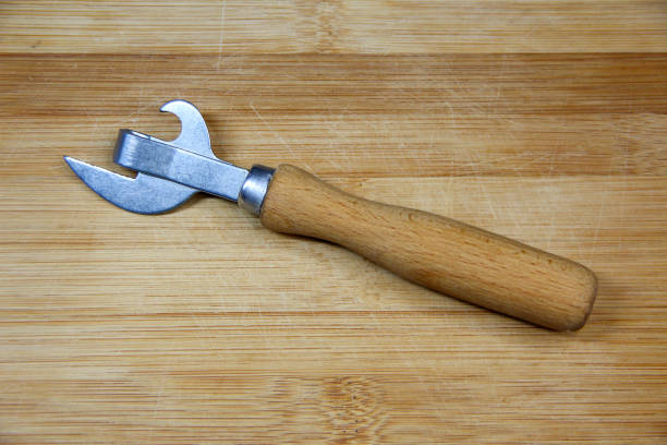 istock Can opener with wooden handle on wooden background 1294403575